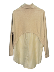 Beige layered turtleneck sweater with a striped button up shirt hem in the back