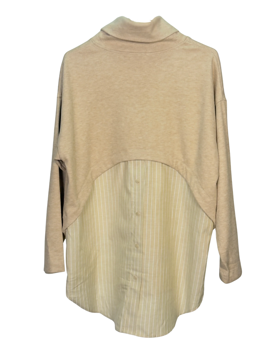 Beige layered turtleneck sweater with a striped button up shirt hem in the back