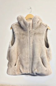 Beige fleece vest on a wooden hanger against a white background