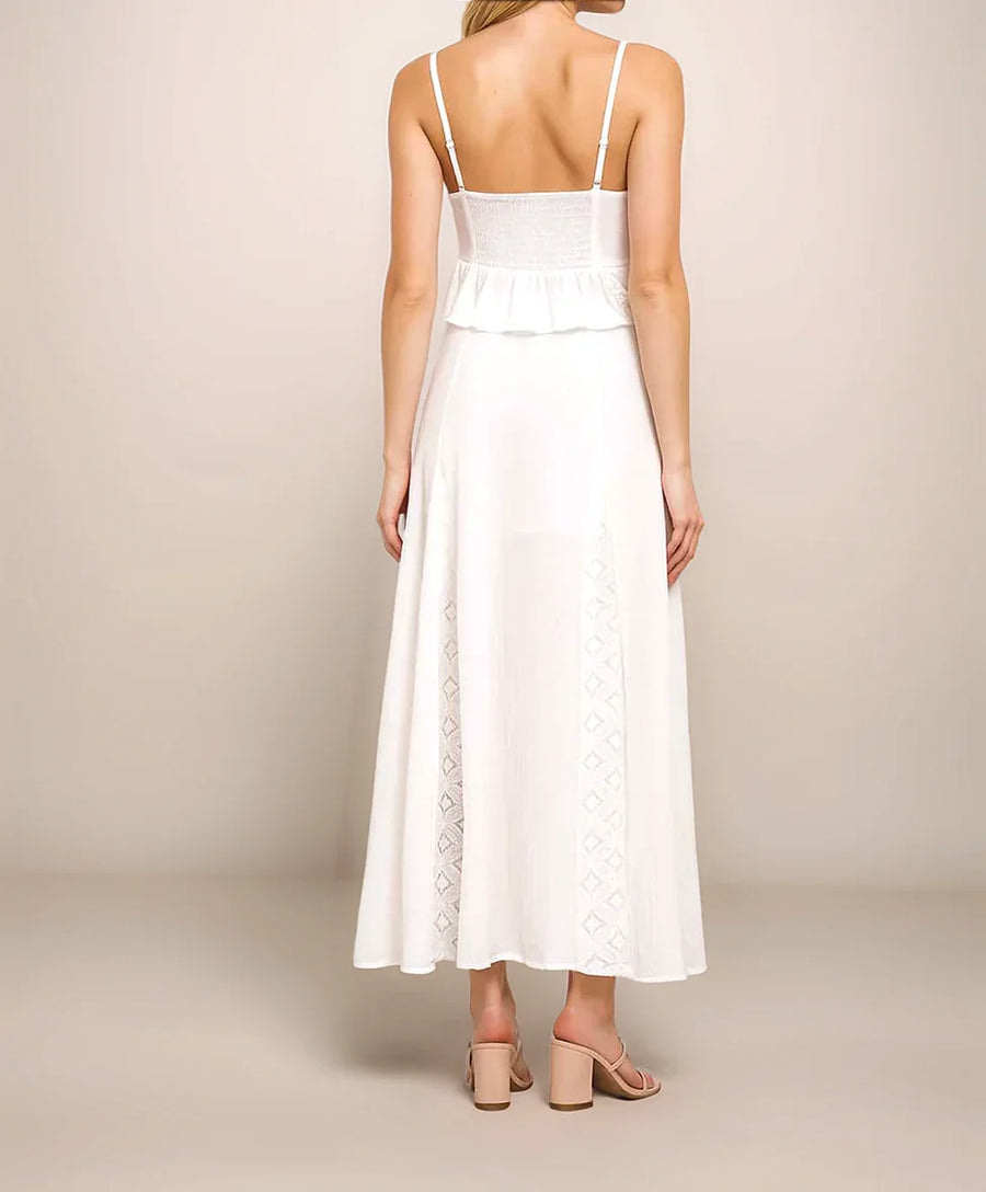 White dress with lace details on a plain background