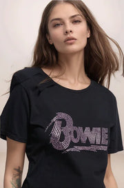 Woman wearing a black t-shirt with 'Bowie' text in rhinestones against a plain background