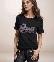 Person wearing a black t-shirt with 'Bowie' design on a plain background