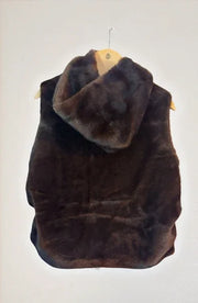 Brown fur vest on a hanger against a white background