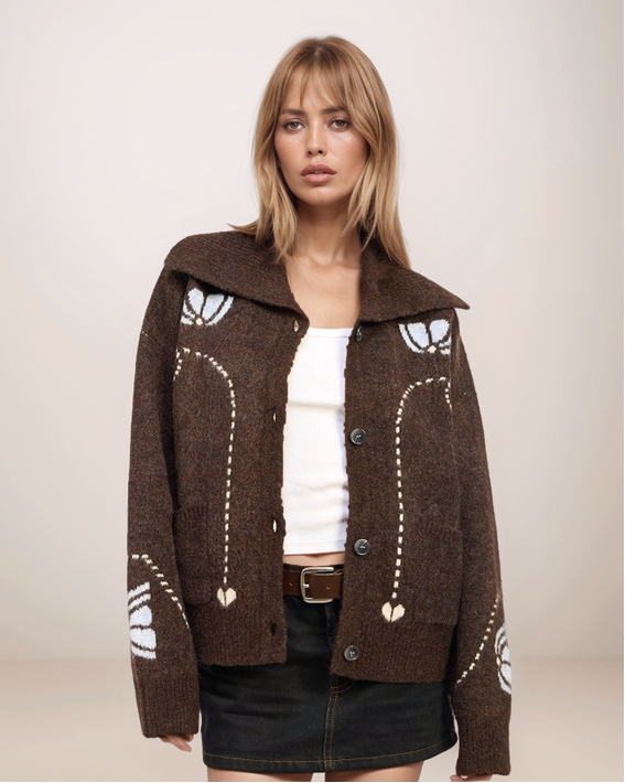 Woman wearing a brown patterned jacket on a plain background