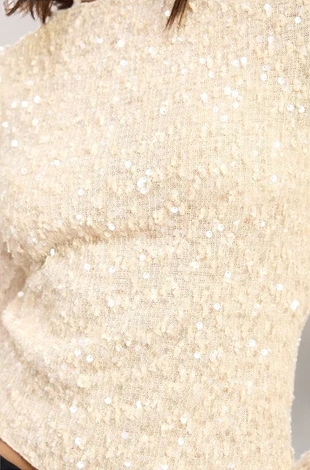 Close-up of a textured beige fabric with a subtle pattern