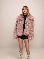 Person wearing a fluffy pink coat on a plain background