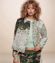 a woman is wearing a floral and camo patchwork jacket with lace contrast.