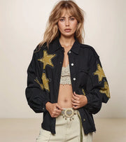 woman wearing a black jacket with gold star patches on the chest and sleeves.