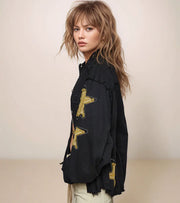 woman wearing a black jacket with gold stars on the sleeve