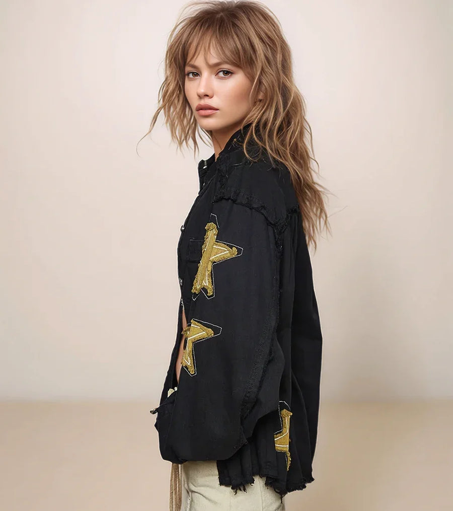 woman wearing a black jacket with gold stars on the sleeve