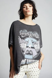 Person wearing a dark gray t-shirt with Aerosmith graphic design on a plain background