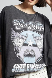 Person wearing a dark gray t-shirt with graphic design and text