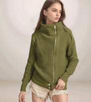Woman wearing a green ribbed sweater with a zipper on a plain background