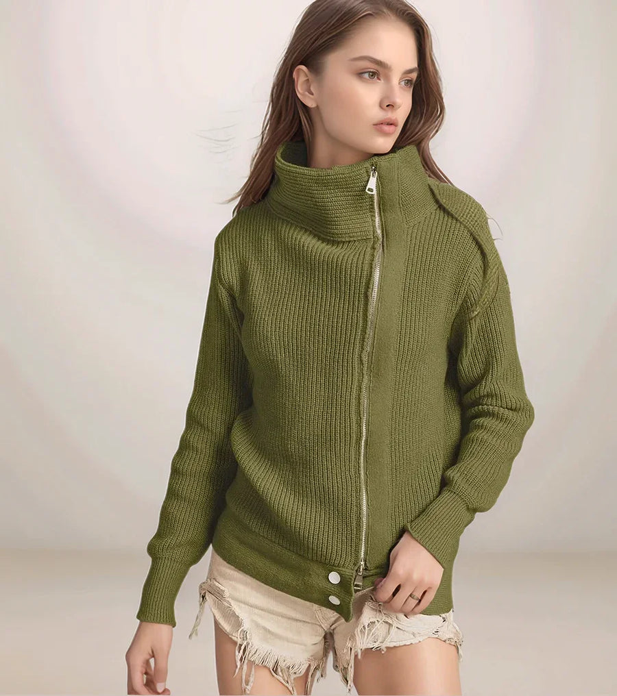 Woman wearing a green ribbed sweater with a zipper on a plain background