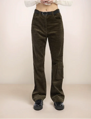 Person wearing olive corduroy pants on a plain background