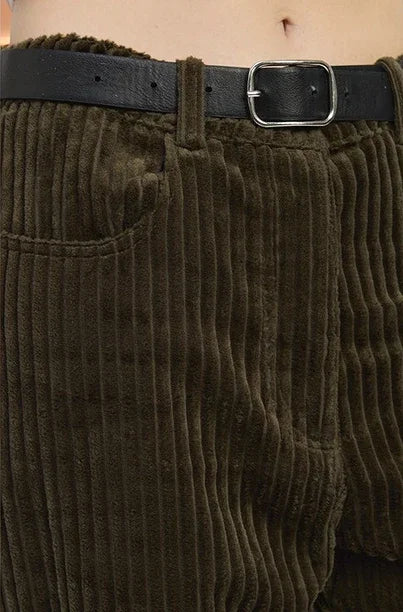 olive green  corduroy pants with a black belt and silver buckle.