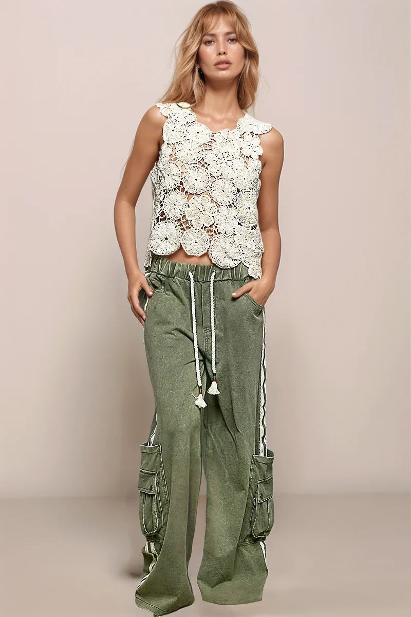 Model wearing the POL Botanica crochet top styled with olive green low slung bottoms, featuring intricate open knit detailing and a relaxed bohemian silhouette.