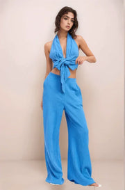 A model modeling the vibrant blue Aegean Double Gauze Wide-Leg Pants, showcasing the flowy fit and functional side pockets in a monochromatic matching set.
