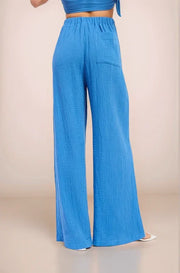 Back view of the Aegean wide-leg pants showcasing the comfortable elastic waistband and functional patch pocket detail.