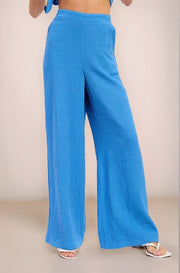 Front view of the Aegean blue 100% cotton double gauze wide-leg pants, highlighting the high-waisted fit and breezy, flowy silhouette.
