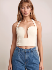 Halter Neck Cutout Top front view in cream with halter neckline and statement front cutout