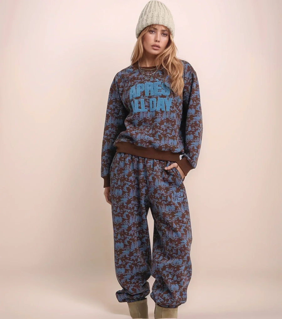 Person wearing a blue patterned outfit with text on a beige background