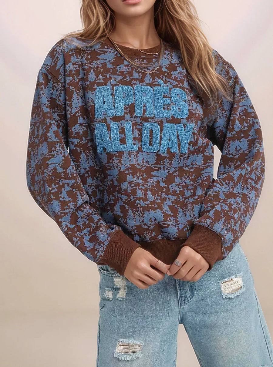 Person wearing a patterned sweater with text and ripped jeans on a plain background