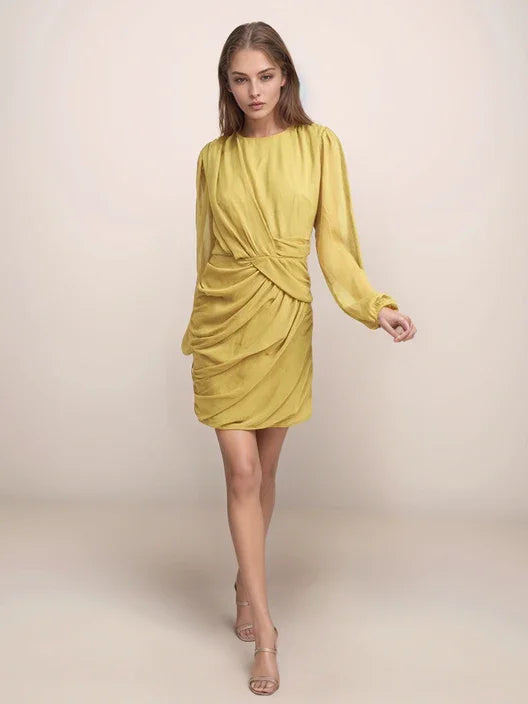 Woman wearing a yellow dress against a plain background
