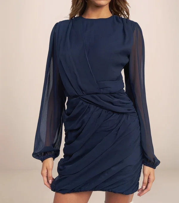 navy blue dress that is draped and has sheer sleeves