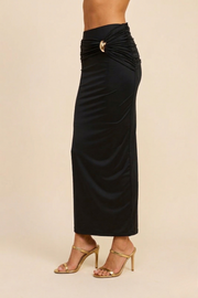 A side view of the Aurelia skirt, illustrating the architectural drape of the Nylon-Spandex blend and the textural dimension created by the integrated side-gathering.