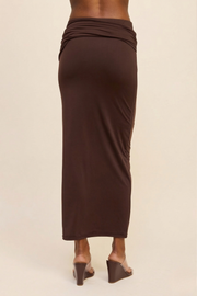 Back view of the brown Aurelia fully lined maxi skirt, highlighting the clean body-con silhouette and the high-stretch fabric's ability to maintain a sleek, opaque finish.
