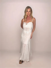 a stylish blonde woman is standing with her legs crossed wearing a matching cotton camisole and maxi skirt that features diamond lace inserts and a lining on the bust and to mid thigh.