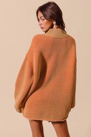 Woman wearing an orange and tan knitted sweater against a beige background