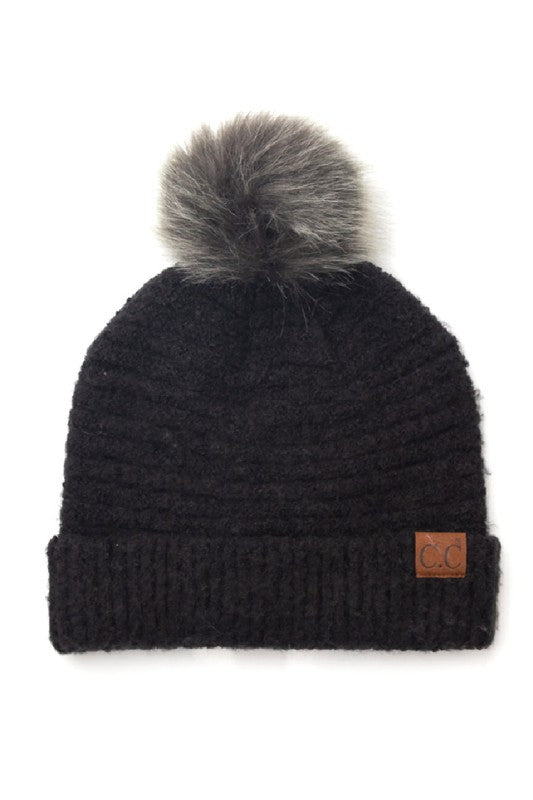 Black knit beanie with gray pom-pom on a white background