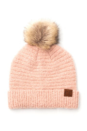 Pink knit beanie with a fur pom-pom on a white background