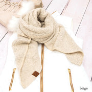 Beige scarf with gold zippers on a white wooden surface