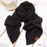 Black scarf with a brand label on a white surface