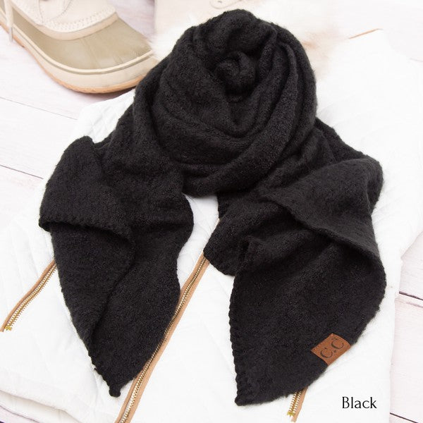Black scarf with a brand label on a white surface