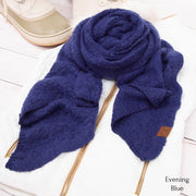 Blue scarf with a brand label on a white surface