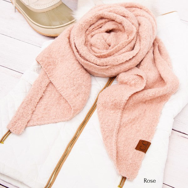 Pink scarf with a brand tag on a white background