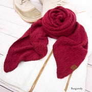 Burgundy scarf with gold zipper on a white surface