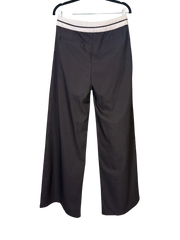 Black wide-leg pants on a hanger against a white background