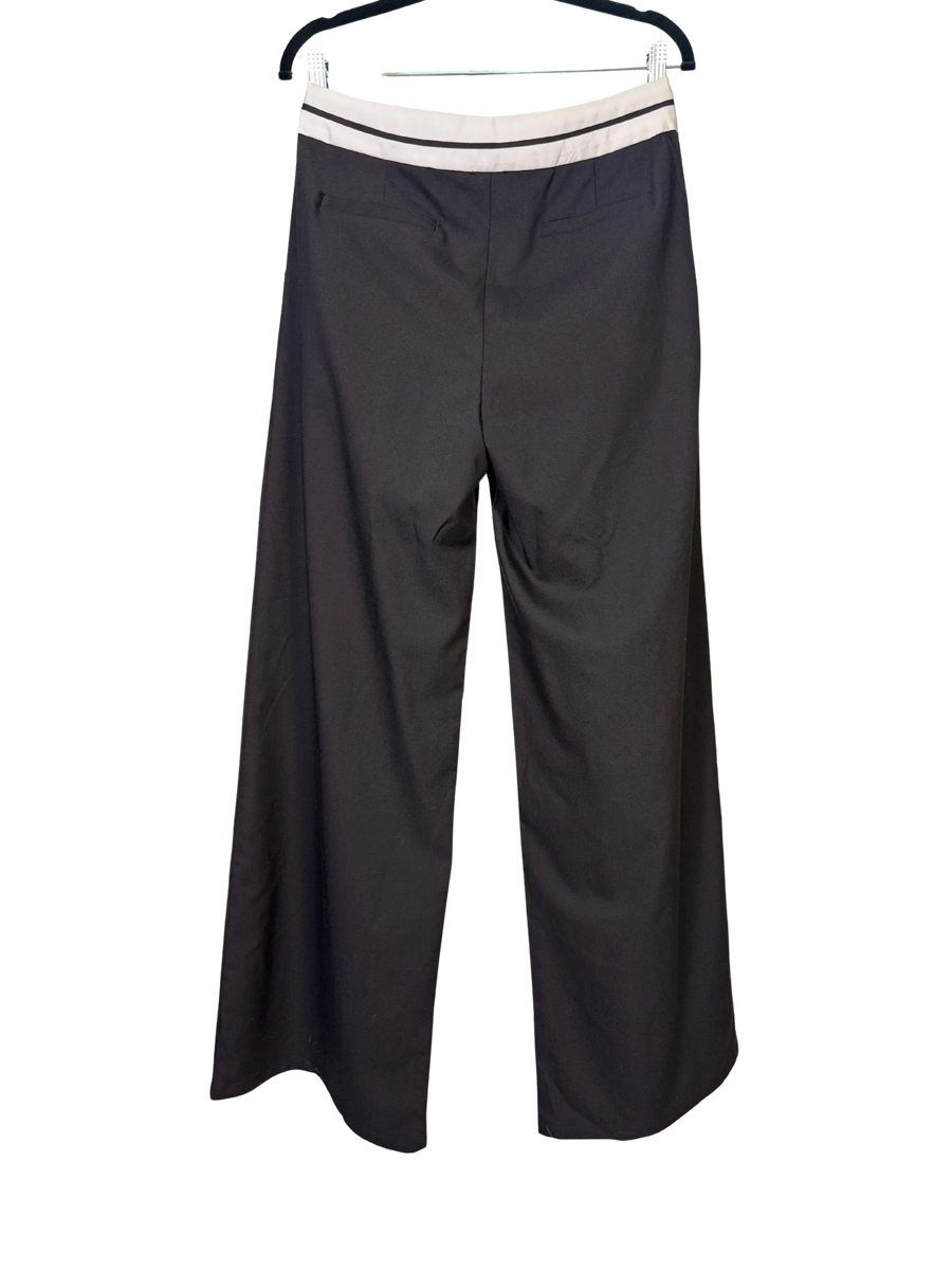 Black wide-leg pants on a hanger against a white background