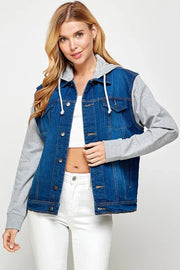 Woman wearing a denim and gray jacket on a white background