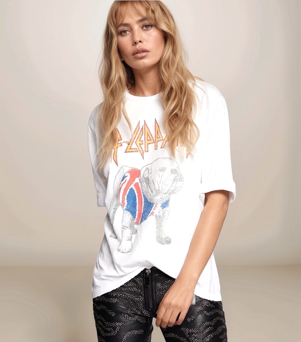 Woman wearing a white t-shirt with a graphic design on a plain background