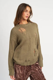 Woman wearing a green distressed sweater on a white background