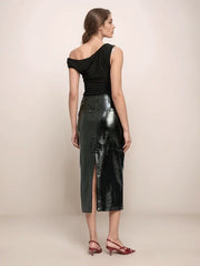 a woman wearing a black leather skirt that has a slit in the back and a black top 