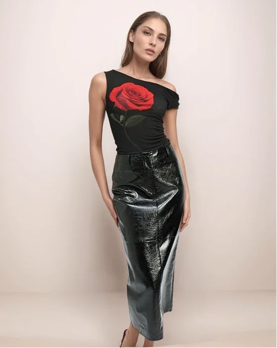 a woman wearing a black leather skirt and a black top