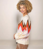 Woman wearing a patterned sweater against a plain background