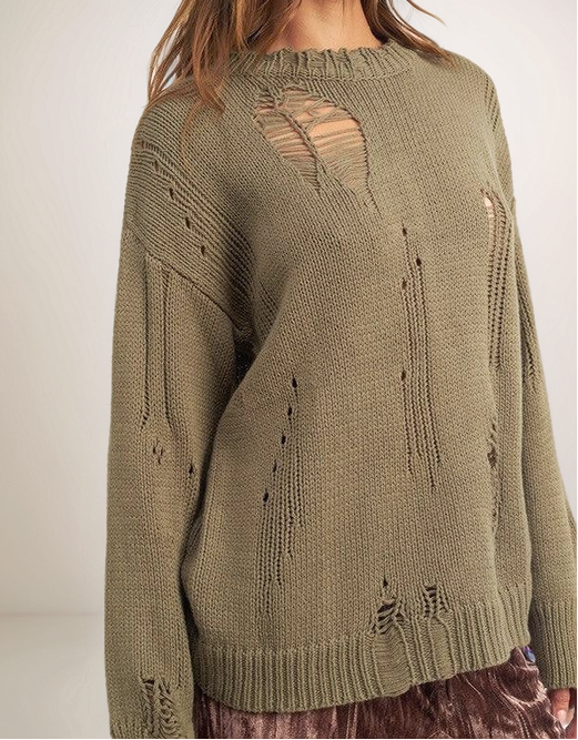 Green knitted sweater with cut-out design on a plain background